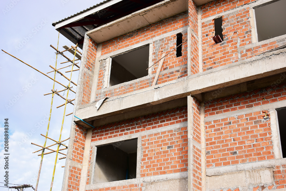 Obraz premium exterior view of brick house under construction with concrete structure