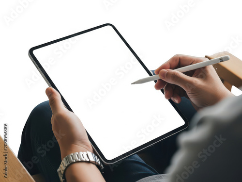 A person is holding a tablet and stylus in their hands