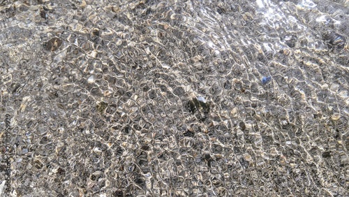 Clear Shallow Sea Water Texture with Sunlight Ripples, Crystal Ocean Surface Background, Natural Wave Pattern