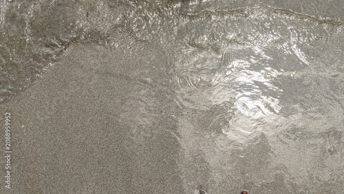 Ocean Wave on Sandy Beach Background