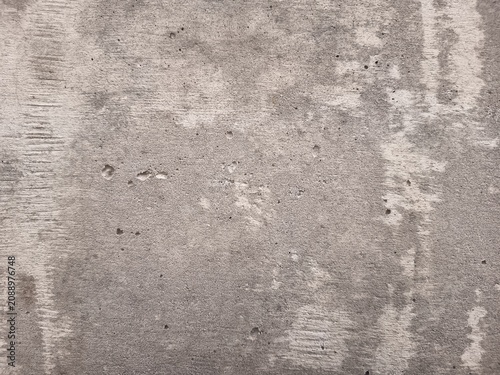 Fotografie Full frame texture of dry weathered concrete surface with fine cracks and rough