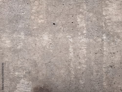Fotografie Full frame texture of dry weathered concrete surface with fine cracks and rough