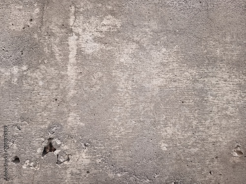 Fotografie Full frame texture of dry weathered concrete surface with fine cracks and rough