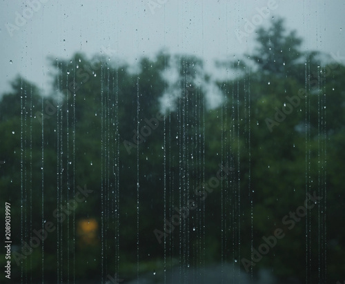 Rain is falling on the window.