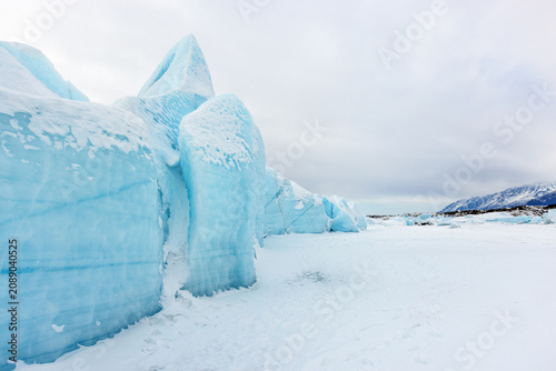 Fotografie Striking Blue Ice Formations and Frozen Pools of Knik Glacier near Palmer Alaska