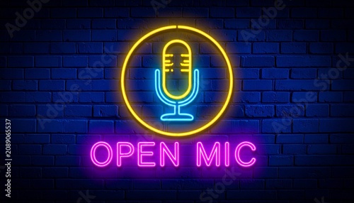 Neon microphone sign glowing with bold “Open Mic” lettering