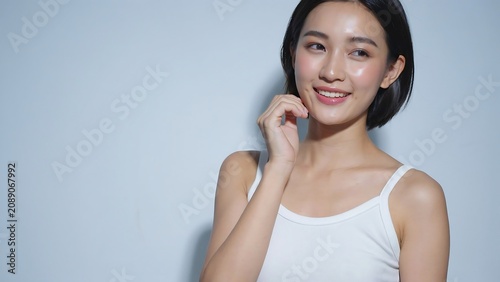 Asian Woman Smiling Wearing White Tank Top on Grey Background