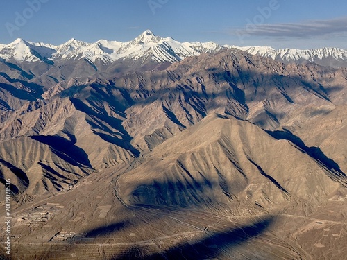 Contrasting landscape of snow-covered mountains and arid slopes