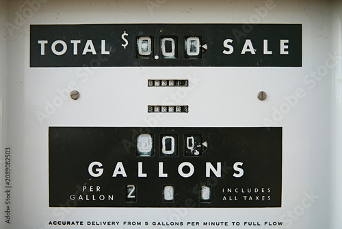 close up of old sign petrol pump with the price of fuel per gallon
