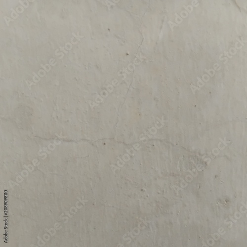 Photos Hairline Wall Crack - Closeup of a painted concrete wall showing fine hairline cracks and textured surface with subtle weathering