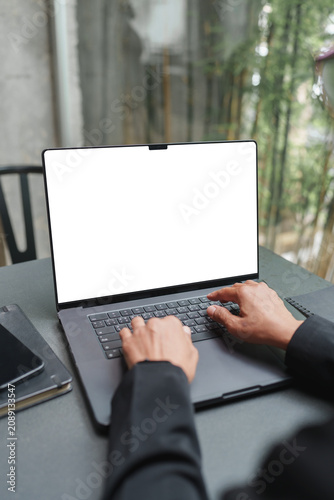 Person typing on laptop mock up screen at workspace