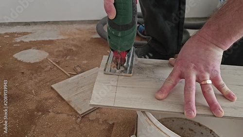Cutting tiles with a power tool in a home setting during a renovation project