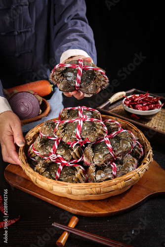 Fresh Yangcheng Lake Hairy Crabs from Suzhou in Traditional Bamboo Basket with Red Ribbons - Chinese Delicacy Preparation
