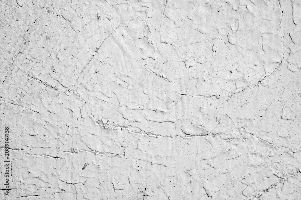 Fototapeta premium Rough white wall surface with visible texture and cracks