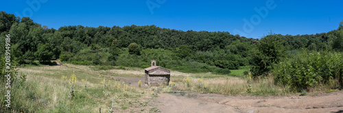Santa Margarida volcano crater in La Garrotxa, Catalonia, Spain. Panoramic view of the small hermitage inside the extinct volcanic crater near Olot.