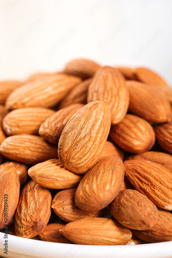 Fototapeta premium Fresh Roasted Almonds in White Bowl