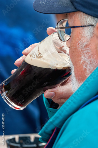 Man drinking beer from pint glass