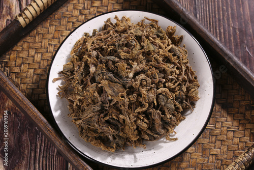 Traditional Chinese Dried Preserved Vegetables Xuelihong on Bamboo Mat with Chopsticks