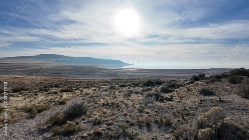Ambient shot of a scenic landscape at Antelope Island, Great Salt Lake, Utah. Calm day with bright sun and subtle organic handheld camera movement.