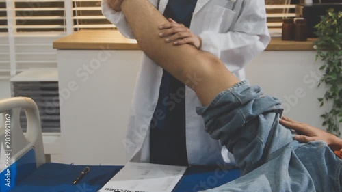 Healthcare, knee and physiotherapist with man patient in clinic for healing, rehabilitation or treatment. Physical therapy, stretch and medical worker with athlete for leg injury or accident recovery