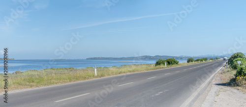 Photos road on isthmus from sant Antioco to Sardinia with wind farm and industrial plan