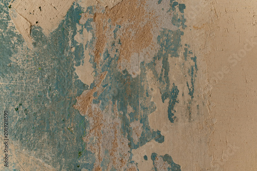 Fotografía Weathered paint peels off rough beige wall