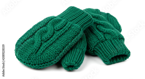 Pair of green knitted cable stitch mittens on white background