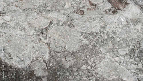 фотографія Weathered gray conglomerate rock showing embedded pebbles and mineral textures