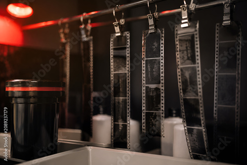 Film development in a traditional darkroom. Film negatives. Red light