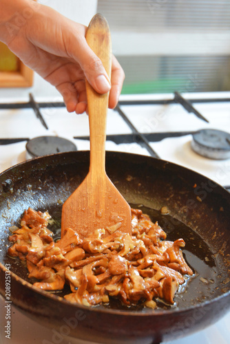 Chanterelle mushrooms frying in pan