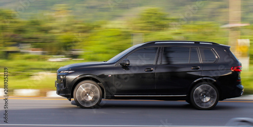 pan shot  black suv car on the road blure image soft focus