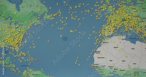 Time lapse of busy air traffic over map on digital screen.
