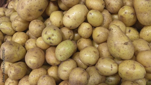 Close-up of new potatoes in boxes in the supermarket. Grocery store. Harvesting organic vegetables. Farmers' market with a variety of fresh vegetables.