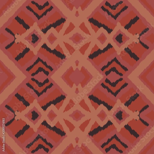 Seamless ethnic ikat pattern with intricate orange, coral pink, and navy blue geometric diamond motifs. Detailed tribal design perfect for bohemian fabric prints, wallpaper, and creative decor.