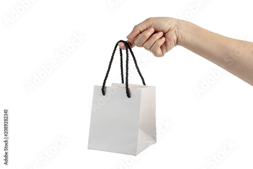 A small white paper bag, a white shopping bag, a white paper bag in hand, on transparent background. 