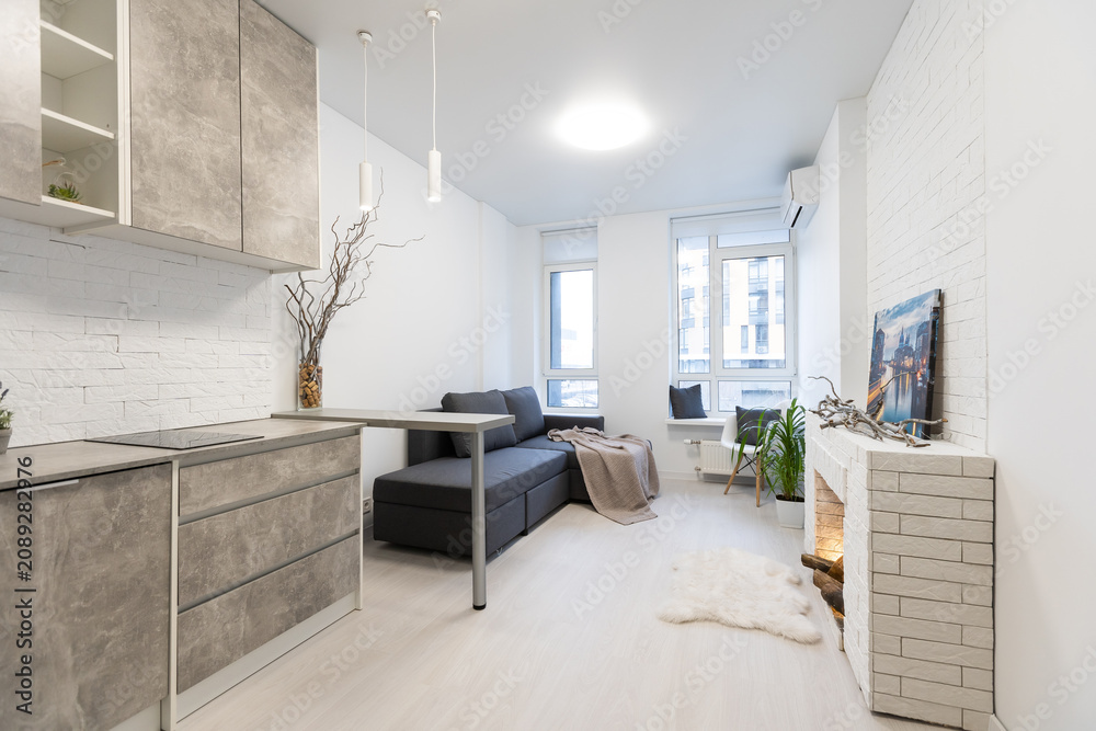 Fototapeta premium Studio interior with fireplace. The interior of a small country house. Apartment with fireplace. The interior of the hotel room. Loft style house.