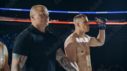 Bild auf Leinwand Two MMA Fighters Fight Trade Punches, Kicks, and Clinch Work Inside a Cage, Circ