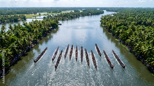 Aerial drone view of traditional Kerala snake boat race on backwater river, cultural heritage water sport South India