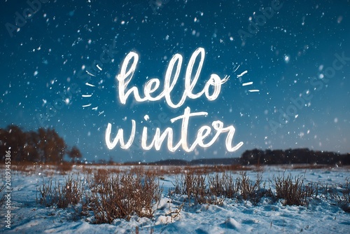 Embracing the enchanting beauty of winter, the snowy landscape captivates the heart, while a cheerful greeting shines brightly in the sky