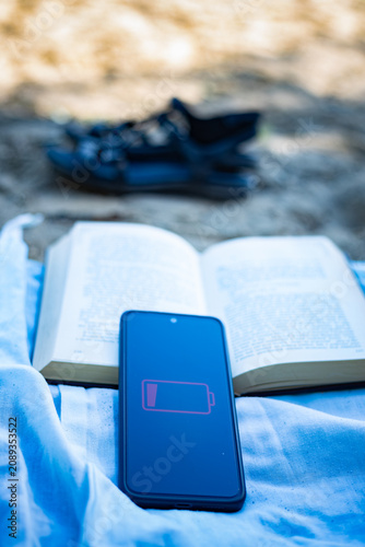 Low battery smartphone during power outage in Ukraine caused by war