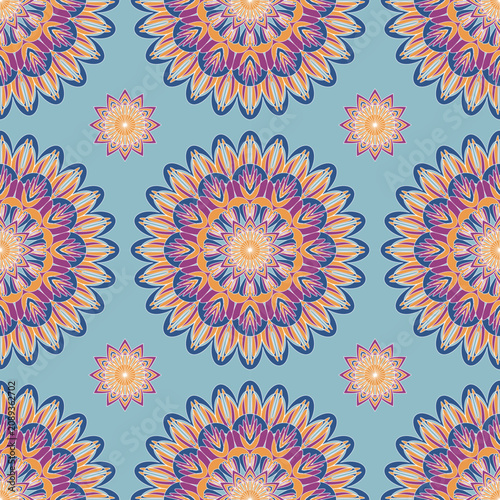 Elegant seamless floral mandala with layered orange, purple, and cream petals on a soft blue background. Perfect for textiles, wallpaper, home décor, fashion, packaging, and stationery.