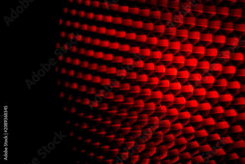 Closeup honeycomb grid texture with red light. Red and dark metal hexagon shaped pattern abstract background. Light modifier equipment. Metal honeycomb. Futuristic pattern. Honey grid cells network.