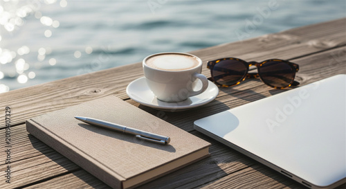 Remote work lifestyle on wooden deck, laptop with coffee cup and notebook by the sea, digital nomad workspace with ocean view