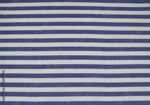 Texture of classic blue and white horizontal striped cotton cloth. Close up of blue striped fabric background.