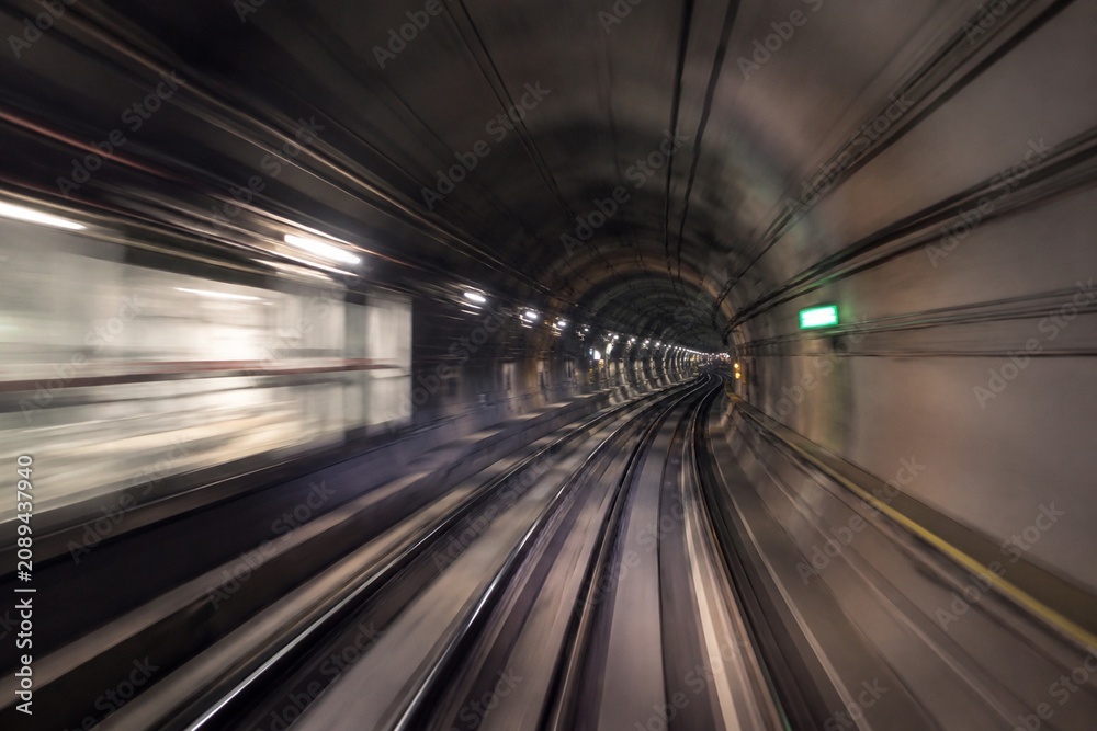 Fototapeta premium Perspective view of a subway tunnel with motion blur, capturing urban transportation atmosphere.