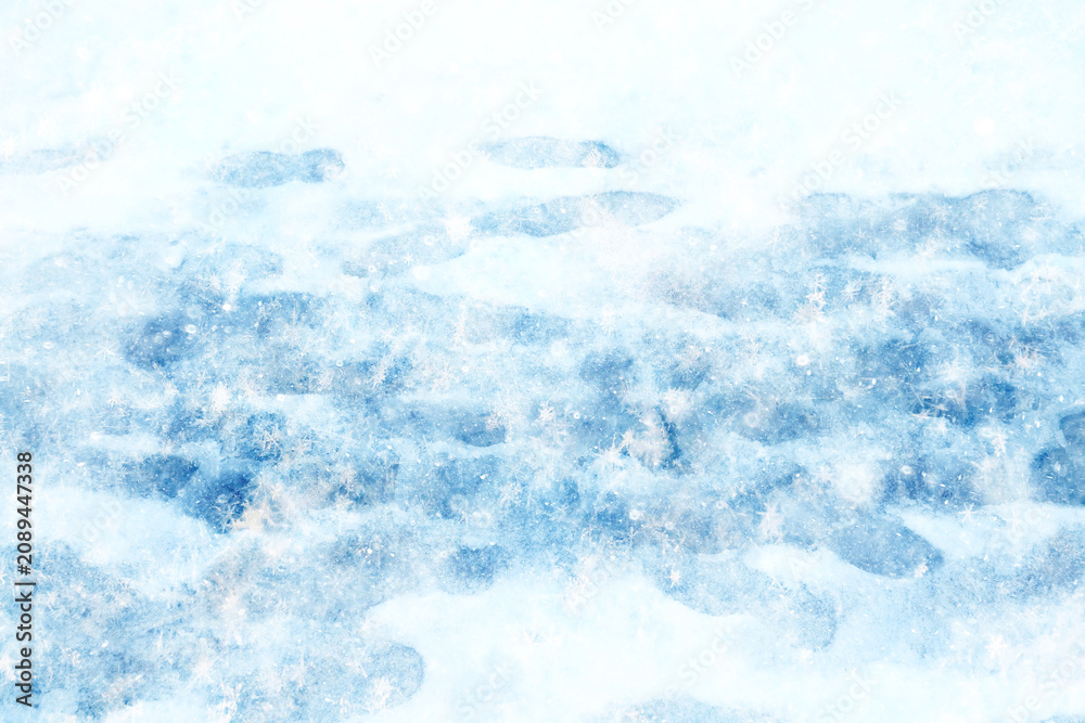 Naklejka premium Footprints in the snow, winter background, pavement surface with footprints in the city, winter weather background