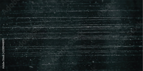Foto Dark worn metal texture with fine horizontal scratches and dust particles surfac