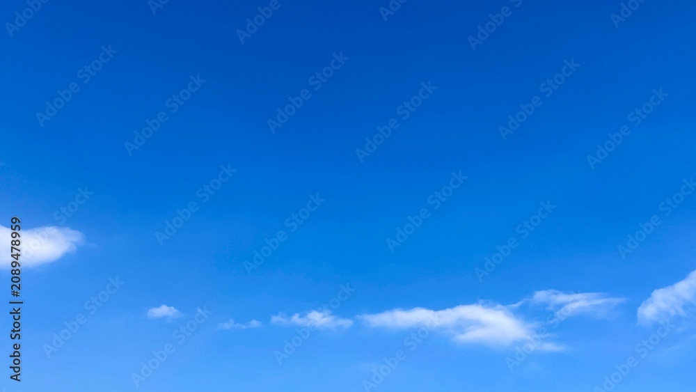 Obraz premium Beautiful clear blue sky with white clouds background