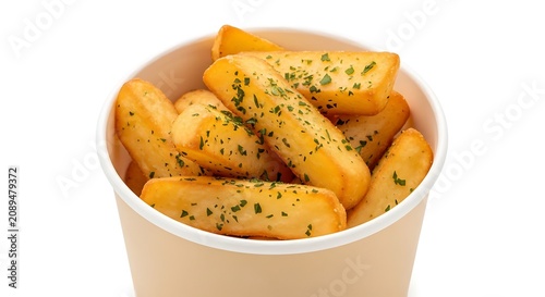A paper cup filled with golden crispy potato wedges seasoned with green herbs, isolated on a white background, for fast food menu