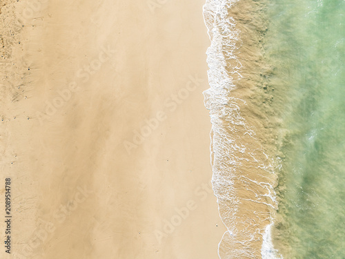 Captured from a drone directly overhead, the meeting of the turquoise sea and white sand makes for a stunning backdrop